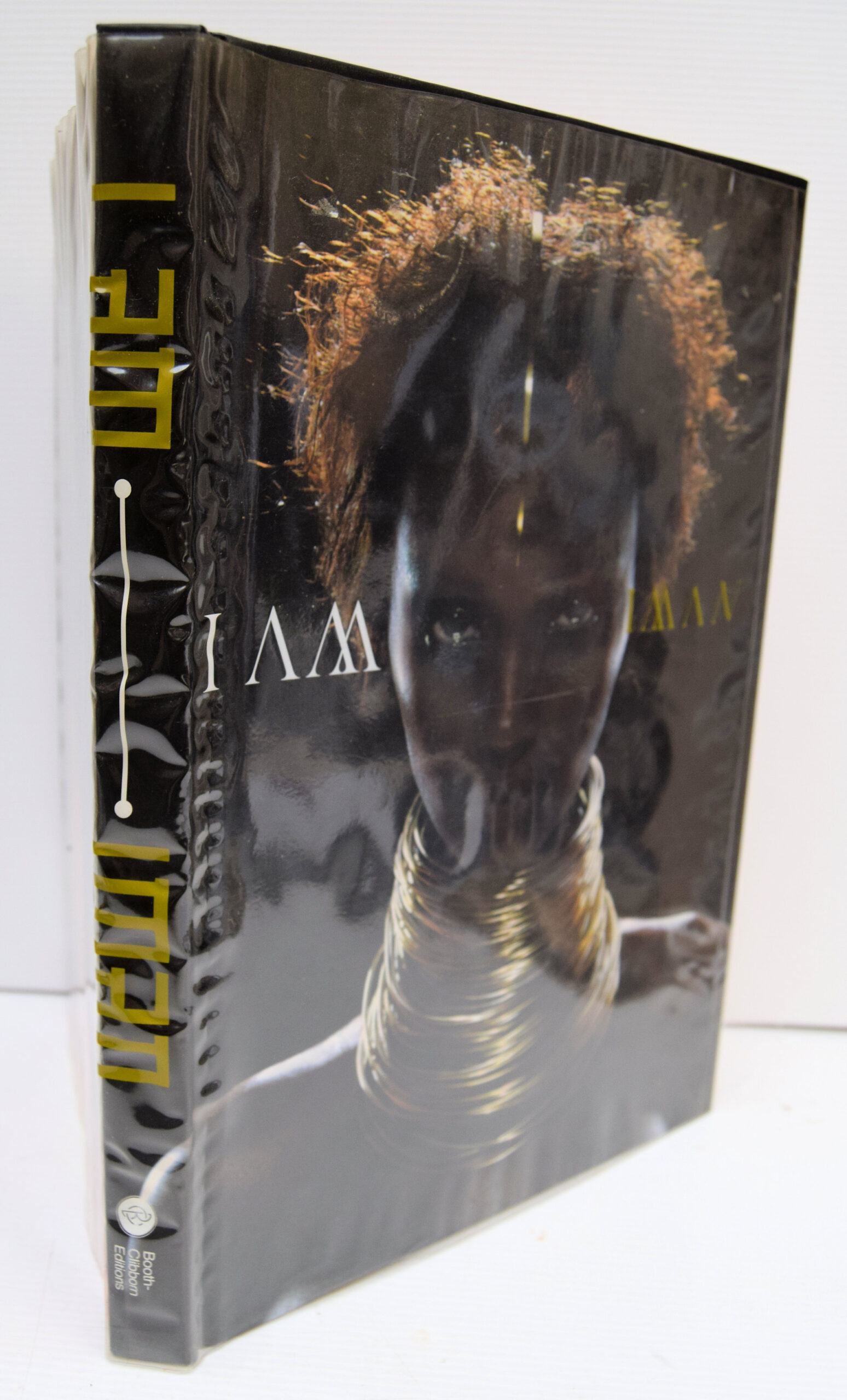 IMAN: Her first book is a gloriously entertaining hybrid essay on the cultural-cum-political power of good looks. A quarter century of the most famous photographs by Helmut Newton, Steven Meisel, Herb Ritts, Peter Lindbergh, Bruce Weber, Scavullo, David Bailey, Nick Knight, and many others are contextualized by well-known essayists, a chorus of celebrity contributions, and Iman's own take on her much-mythologized career. The book's outrageous pop design--by graphic designers Barnbrook Studios--makes it plain that this is not just one woman's success story. "I Am Iman" captures the funny, infuriating, and often absurd validation of black and ethnic looks in a beauty industry where billions of dollars--and the self-image of women everywhere--are on the line. Peeks behind the curtain and scintillating interviews are courtesy of feminist critic bell hooks, "Interview" editor Ingrid Sischy, model and manager Bethann Hardison, and such celebrities as Cindy Crawford, Yves St. Laurent, Naomi Campbell, Bruce Weber, Tyra Banks, and many more. With graphic design featuring gatefolds, diecuts, and other interactive elements, as well as specially commissioned, never-before-seen images by Annie Leibowitz, Ellen Von Unwerth, Sante D'Orazio, and Michel Comte, this book is an assemblage worthy of any fashionista's dream.